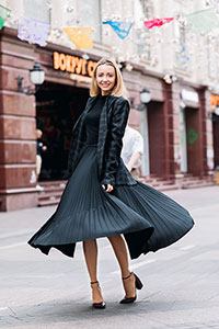 Woman wearing a vintage black pleated dress
