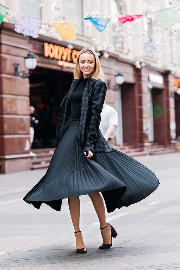 Woman wearing a vintage black pleated dress