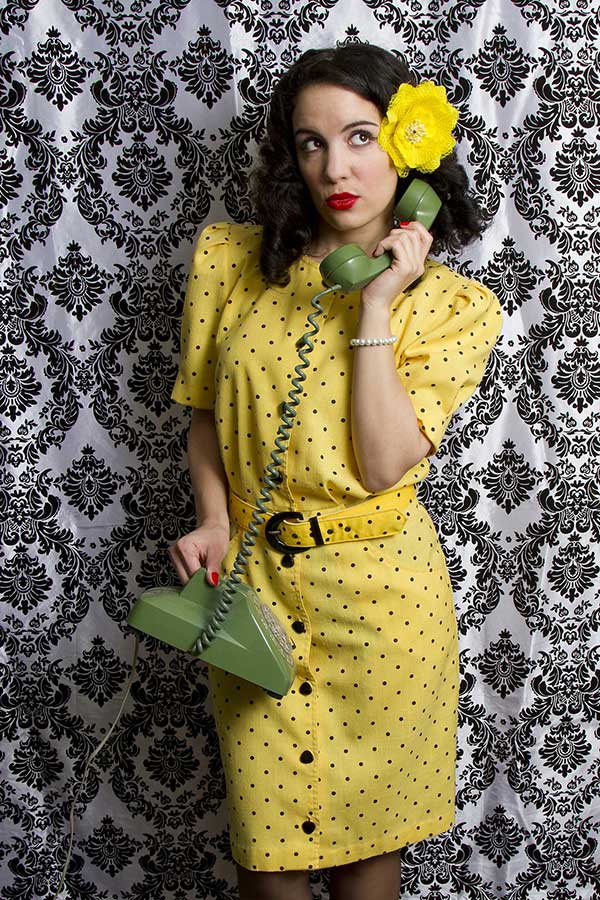 Woman wearing a black spotted yellow dress