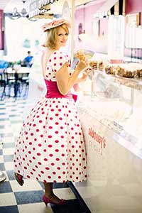 Woman wearing a vintage pink spotted white dress